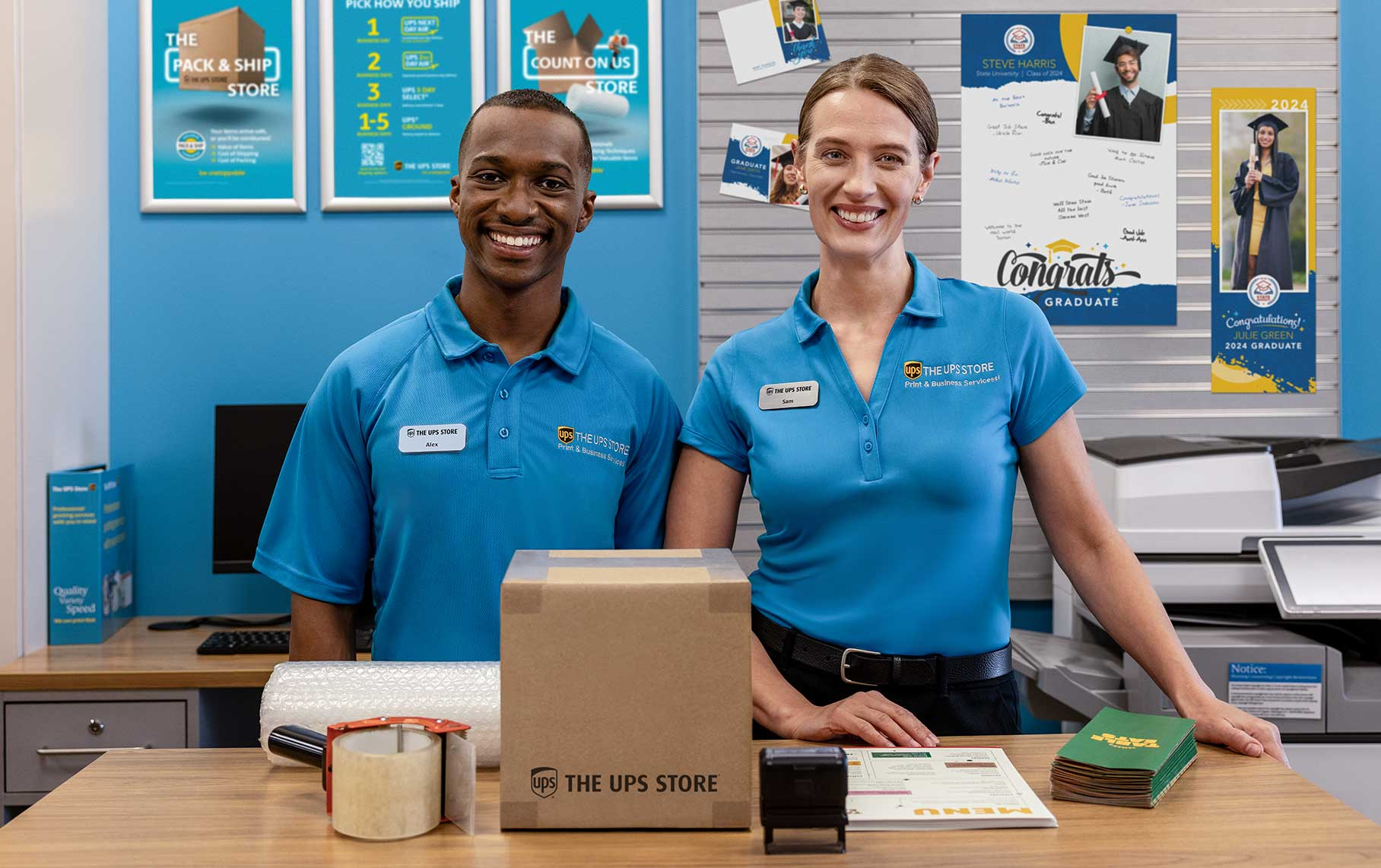 Image of two smiling The UPS Store employees in store
